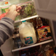Person reaching into refrigerator